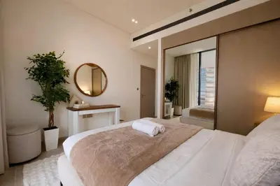 a bedroom with a large bed and a mirror at Binghatti Royale Luxe 1BR W Private Pool Parking in Dubai