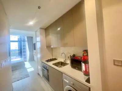a small kitchen with a sink and a stove at Studio in Azizi Riviera, 45 in Dubai