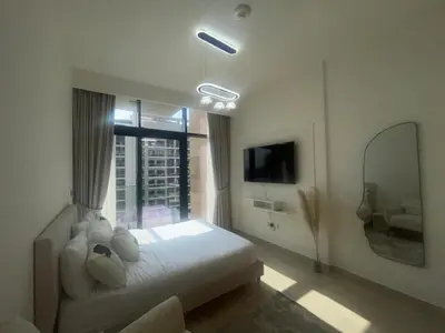 a bedroom with a large white bed and a window at Studio in Azizi Riviera, 45 in Dubai