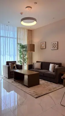 a living room with a couch and a coffee table at Exclusive 2BR Apartment - Prime Al Furjan-707 in Dubai