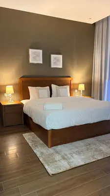 a bedroom with a large bed with two lamps on tables at Exclusive 2BR Apartment - Prime Al Furjan-707 in Dubai