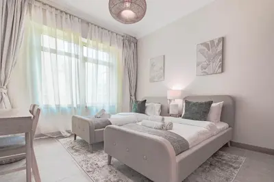 a bedroom with a large bed and a window at HAVN - Spacious 2 Bed in Al Hallawi, Palm Jumeirah in Dubai