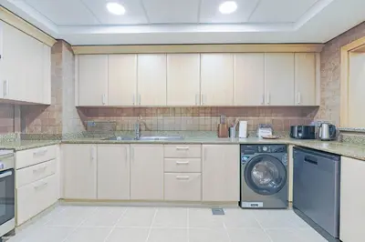 a kitchen with a washer and a dishwasher at HAVN - Spacious 2 Bed in Al Hallawi, Palm Jumeirah in Dubai