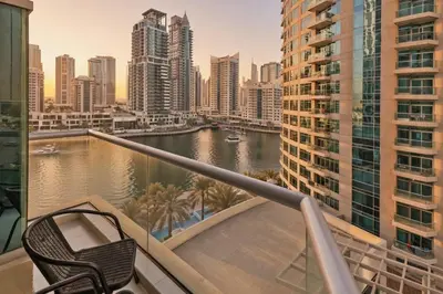 a balcony with a view of a river and buildings at 1 Bedroom Deluxe Apartment with Marina Views in Dubai