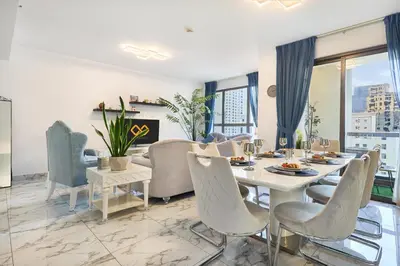 a dining room with a table and chairs at 3-Bedroom Residence in Murjan 5 - Jumeirah Beach with Sea Views in Dubai