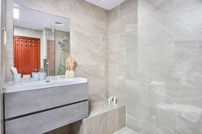 a bathroom with a sink and a shower at 3-Bedroom Residence in Murjan 5 - Jumeirah Beach with Sea Views in Dubai