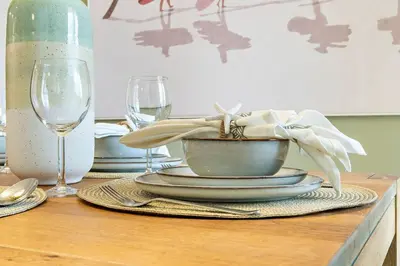 a table with plates and wine glasses on a table at The Smart Concierge - Murjan 5 in Dubai