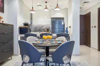 a dining room with a table and chairs at Nobles Tower Business Bay - Modern 1-Bedroom Apartment in Dubai