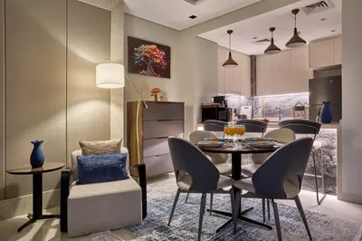 a kitchen and dining room with a table and chairs at Nobles Tower Business Bay - Modern 1-Bedroom Apartment in Dubai