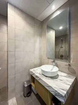 a bathroom with a sink and a mirror at Nasma Luxury stays- Lavish with luxury facilities in Aykon city in Dubai