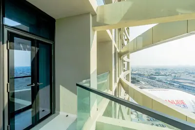 an open balcony with a view of a city at Nasma Luxury stays- Lavish with luxury facilities in Aykon city in Dubai