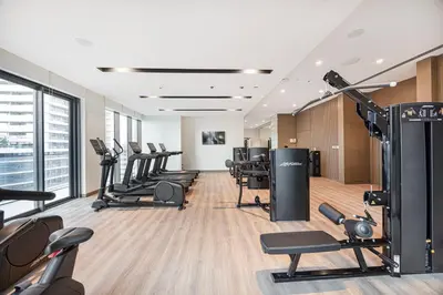 a gym with a row of treadmills and machines at Classy Stay at Beach Mansion with Private Beach in Dubai