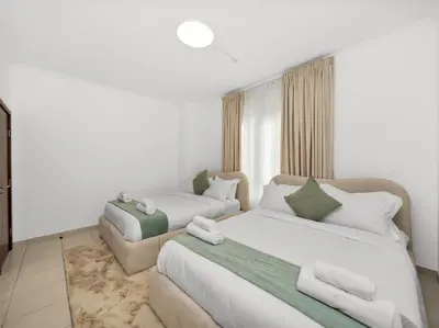 a hotel room with two beds and a couch at By Luxury Space I Luxury two Bedroom Apartment I Front row Downtown with Private Fountain View in Dubai