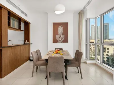 a kitchen and dining room with a table and chairs at By Luxury Space I Luxury two Bedroom Apartment I Front row Downtown with Private Fountain View in Dubai