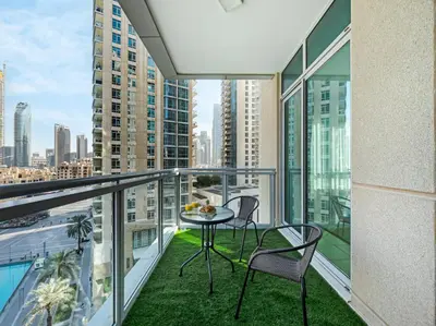 a balcony with a table and chairs and a view of the city at By Luxury Space I Luxury two Bedroom Apartment I Front row Downtown with Private Fountain View in Dubai