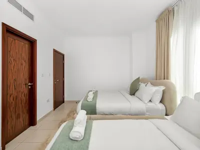 a bedroom with two beds and a couch at By Luxury Space I Luxury two Bedroom Apartment I Front row Downtown with Private Fountain View in Dubai