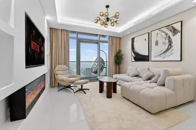 a living room with a couch and chairs and a chandelier at Paramount 59th Floor , Burj View Infinity Pool in Dubai