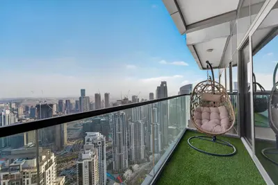 a wicker chair on the observation deck of a skyscraper at Paramount 59th Floor , Burj View Infinity Pool in Dubai