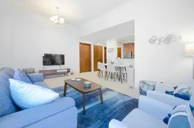 a living room with a couch and a table at Cozy and modern 1 BR Apt in Al Furjan in Dubai