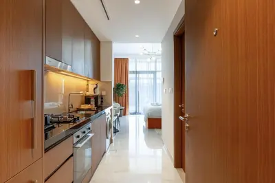 a kitchen with a sink and a stove at Luxury Studio with Pool and Parking at Azizi Vista in Dubai