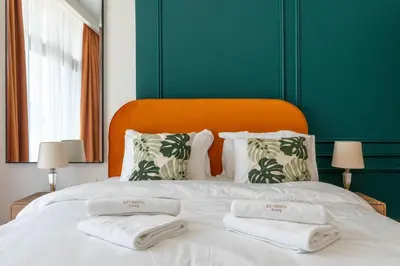 a large white bed with two folded towels on it at Luxury Studio with Pool and Parking at Azizi Vista in Dubai