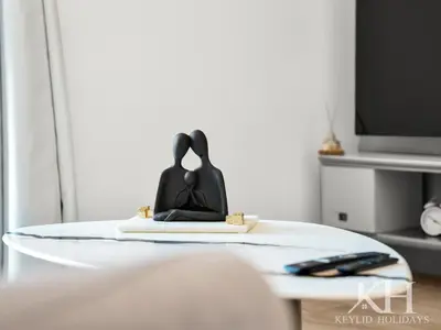 a room with a table with a bed and a tv at keylid Premium 1BR Apartment Dubai Marina in Dubai