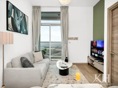 a living room with a couch and a tv at keylid Premium 1BR Apartment Dubai Marina in Dubai
