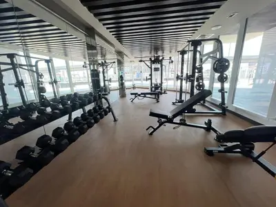 a gym with several treadmills and machines in it at Exclusive Gemz Stay 2BR plus Study w Private Pool-07 in Dubai