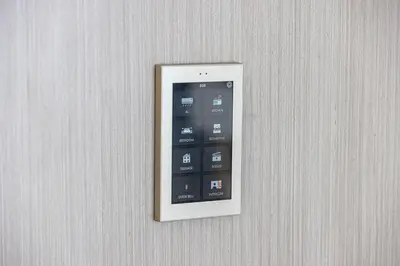 a remote control is attached to a wall at Binghatti Phoenix - Luxury & Modern Studio - Pool & Gym - Free Parking - JVC in Dubai