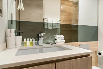 a bathroom with a white sink and a mirror at FIRST CLASS 2BR Modern Luxury Hideaway in Dubai