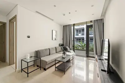 a living room with a couch and two tables at FIRST CLASS 2BR Modern Luxury Hideaway in Dubai