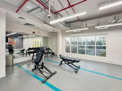a gym with treadmills and chairs in a room at Modern 2-Bedroom Retreat in Remraam - Al Ramth 5 in Dubai