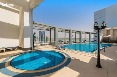a large swimming pool on the side of a building at bnbmehomes - Burj Al Nujoom in Dubai