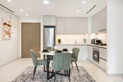 a kitchen with a table and chairs in a room at Blissful Living at Beach Mansion with Private Beach in Dubai