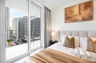 a bedroom with a bed and a large window at Blissful Living at Beach Mansion with Private Beach in Dubai