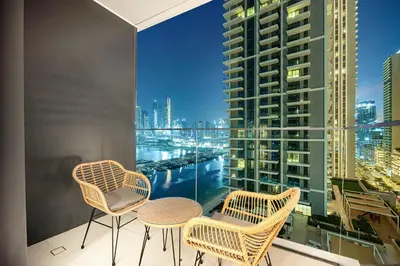 a balcony with chairs and a view of a city at Blissful Living at Beach Mansion with Private Beach in Dubai