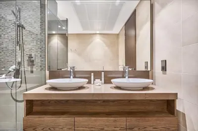 two sinks on a counter in a bathroom at Jumeirah Living Marina Gate - Elegant 1BR Canal View Retreat in Dubai