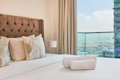 a bedroom with a bed with a large window at Jumeirah Living Marina Gate - Elegant 1BR Canal View Retreat in Dubai