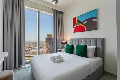 a bedroom with a large bed with a large window at Elegant 2Bed Walk to Burj Khalifa & Dubai Mall in Dubai