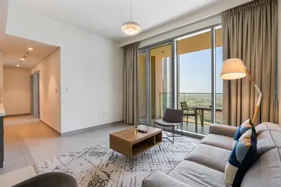 a living room with a couch and a table at Elegant 2Bed Walk to Burj Khalifa & Dubai Mall in Dubai