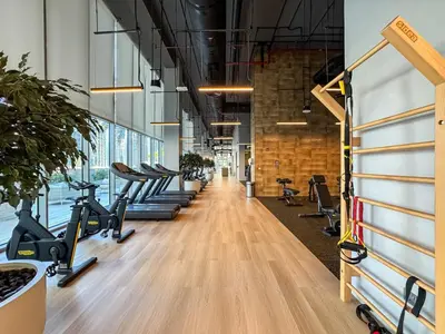 a gym with rows of treadmills and exercise bikes at Elegant 2Bed Walk to Burj Khalifa & Dubai Mall in Dubai