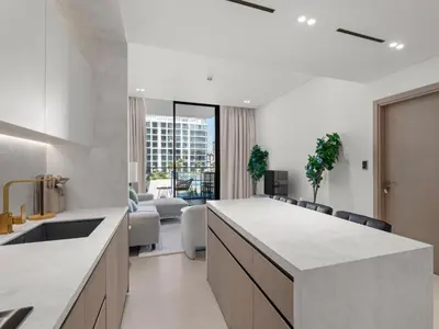 a kitchen with a counter and a living room at Modern 1BR Hideaway In Binghatti Phoenix-JVC in Dubai