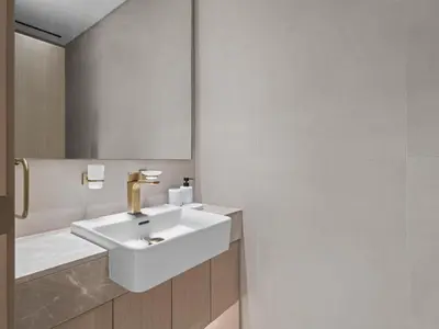 a bathroom with a white sink and a mirror at Modern 1BR Hideaway In Binghatti Phoenix-JVC in Dubai