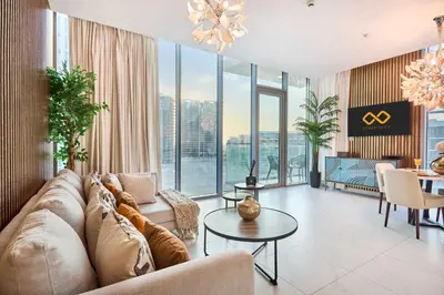 a living room with a couch and a table at Waterfront 2BR District One Residence - Near Downtown and Lagoon in Dubai