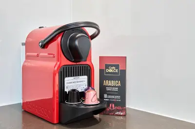 a red toaster next to a box and a book at Waterfront 2BR District One Residence - Near Downtown and Lagoon in Dubai