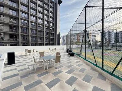 a patio with a table and chairs on a building at Joya Blanca Residence - Bright 1BR Apartment in Arjan in Dubai