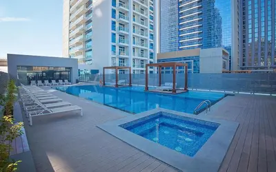 a swimming pool on top of a building with tall buildings at LMY Wharf 2 Marina View Suites - Dubai JBR Marina in Dubai