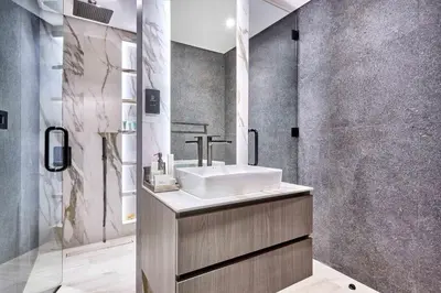 a bathroom with a sink and a shower at Stylish 1BR near Miracle Garden - Oxford Gardens in Dubai