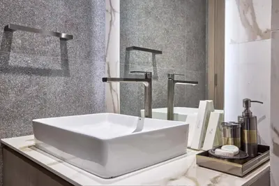 a bathroom with a white sink on a counter at Stylish 1BR near Miracle Garden - Oxford Gardens in Dubai