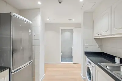 a kitchen with a stainless steel refrigerator and a sink at FIRST CLASS 1BR Panoramic Marina Views in Dubai